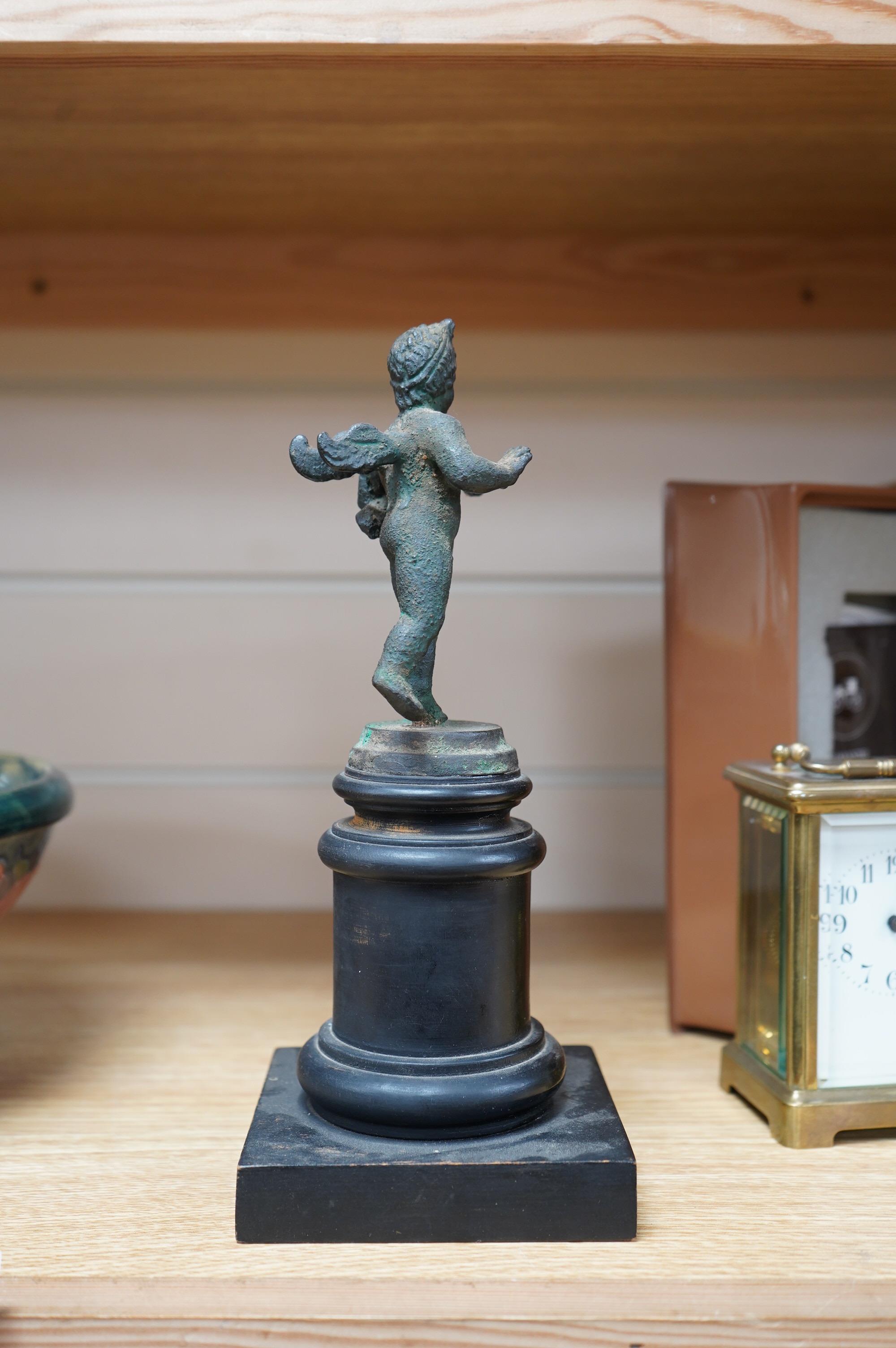 A bronze model of a putto, possibly Roman, holding a duck, on a circular plinth, 24.5cm. Condition - fair to good.